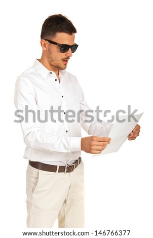 Amazed executive man with sunglasses looking to a paper isolated on white background