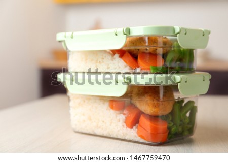 Boxes with prepared meals on table against blurred background