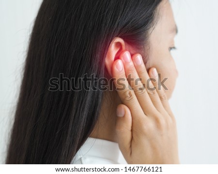 ruptured eardrum,tinnitus and meniere disease and otitis media in asian woman. She use hand touching her ear causes of ear pain on white background use for health care concept. Royalty-Free Stock Photo #1467766121