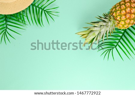 Summer background with hat and pineapple. Copy space.