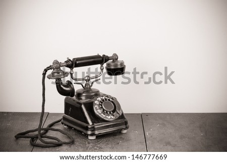 Vintage old telephone on wood table black and white photo