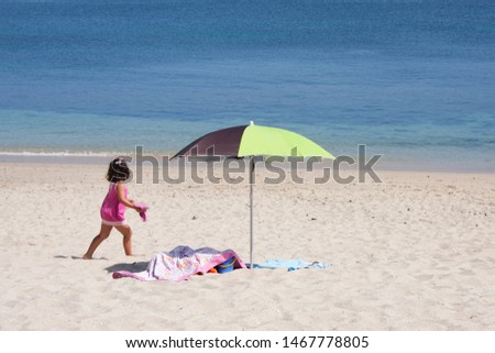 Girl playing on the beach on vacation