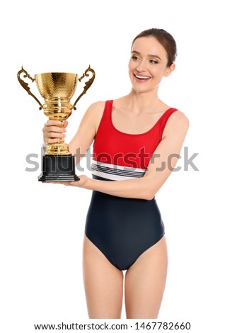 Young woman in swimwear holding golden cup on white background