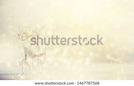 Silver glitter Christmas deer on pink background with lights bokeh, copy space. Greeting card for new year party. Festive holiday concept. Banner.