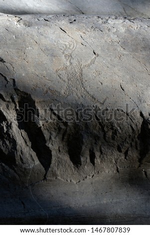 Ancient rock engraving in Camonica Valley, the "running priest", Naquane National Park, UNESCO World Heritage Site, Italy. 