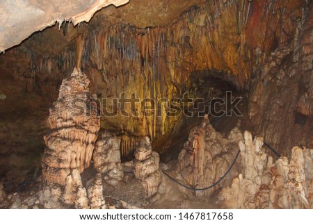 interesting beautiful original cave in the Turkish mountains with stalactites and stalagmites creating the background 