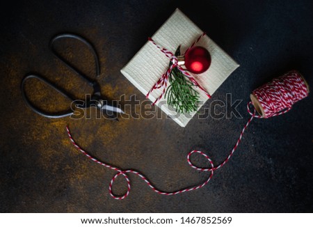 Christmas frame concept with gift box and holiday decor on stone background with copy space
