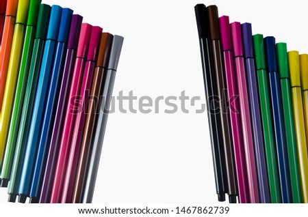 Lots of bright colored pens on white background.
