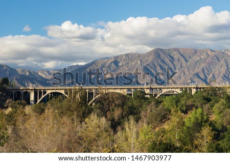 Image of the landmark Colorado Street Bridge in Pasadena with the San Gabriel Mountains in the background. Royalty-Free Stock Photo #1467903977