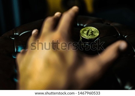 hand of Businessman want to hold bitcoin, Golden Bitcoin icon or logo virtual currency coins (physical) on the dark brown background