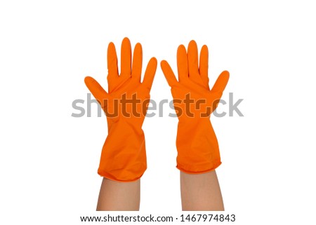 Women's hands putting on the protective orange rubber gloves isolated on white background