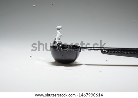 the action of water splash with black spoon