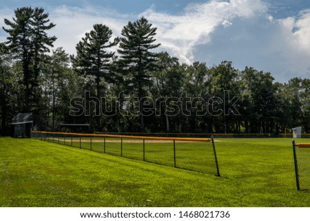 baseball court side view with a beatiful blue sky and white clouds