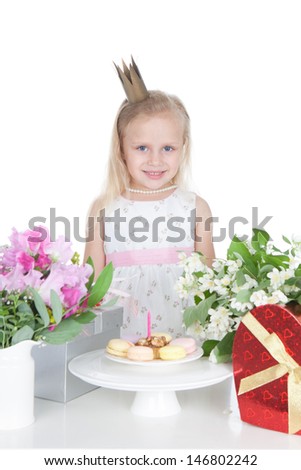 Picture of funny smiling little girl with birthday cake on white background