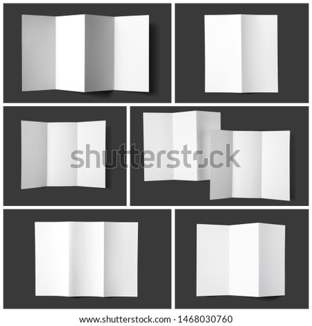 Set of blank brochures on dark grey background, top view. Mock up for design