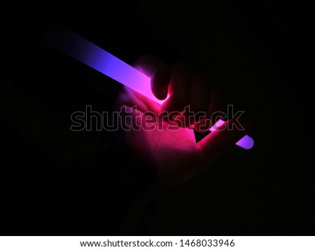 Hands Holding neonlights in the Night