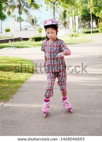 Asian girl playing roller skating in the park outdoor, lifestyle concept.