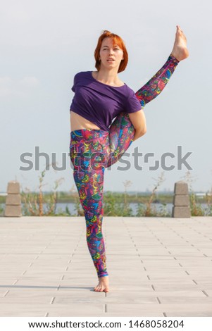Beautiful Woman doing Yoga Exercises in the Park. Portrait.