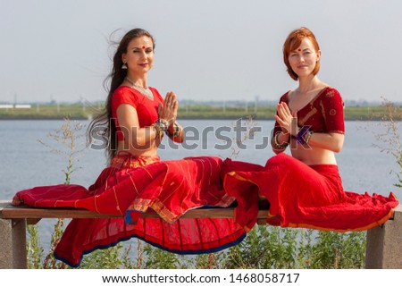 Pair of girls practice yoga. Women in a traditional saree. Portrait.
