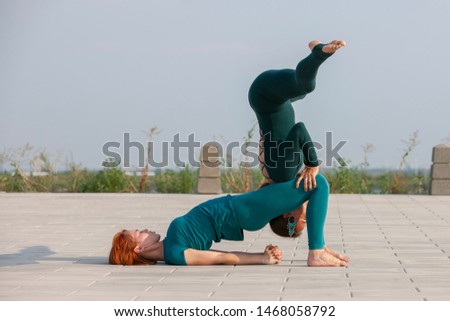 Fitness, stretching practice, group of two attractive women doing yoga. Wellness concept. Portrait.
