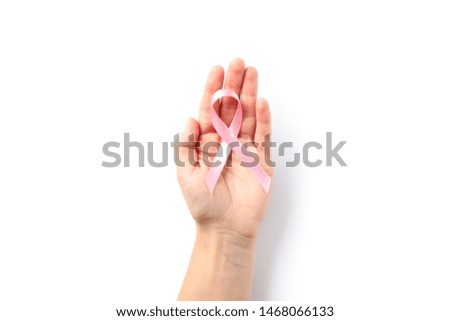 Female hand hold pink awareness ribbon, isolated on white background