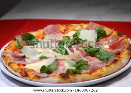 
italian Pizza prosciutto parmesan cheese and rucula