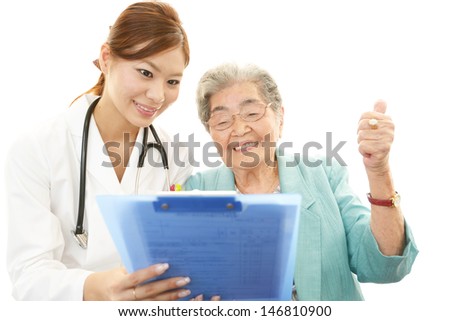 Smiling Asian medical doctor and senior woman