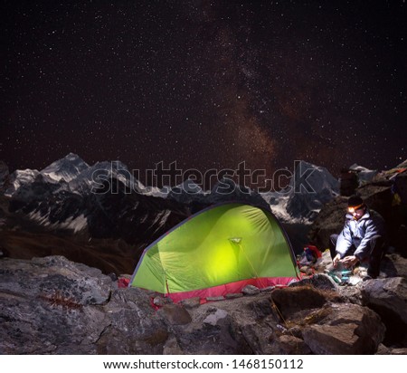 Evening camp on Gokyo Ri hill (about 5400m) with a view of Mount Everest (8848 m),romantic dinner near to the tent under the starry sky and overlooking the highest peak of the planet. Nepal, Himalayas