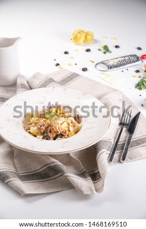 Pasta with Fresh Tuna and Corn and Olives Served in a White Plate