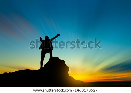 silhouette of man on mountain top over sky and sun light background, business, success, leadership, achievement and motivated concept