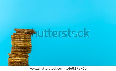 a column of coins in the background, a place for your text or picture or illustration, selective focus