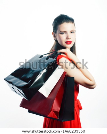 young pretty blond woman posing cheerful isolated on white background with bags on Christmas sale in red dres