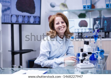 Smiling senior doctor woman working with microscope at laborator. Modern scientist. Royalty-Free Stock Photo #1468227947