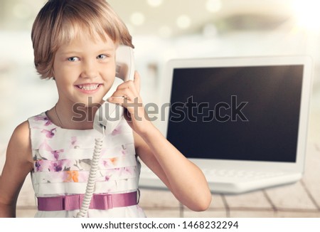 Child Emotional phone talk and white laptop