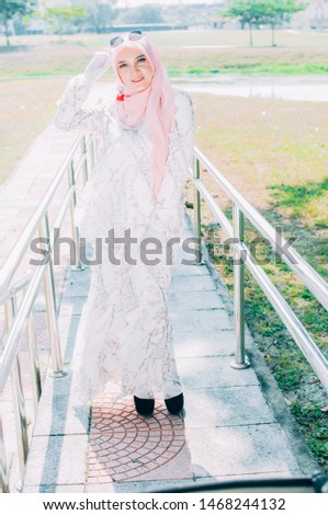 Portrait of muslim elegant woman 20s in hijab smiling and looking at camera