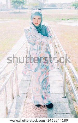 Portrait of muslim elegant woman 20s in hijab smiling and looking at camera