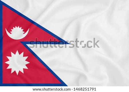 Flag of Nepal on textured fabric. Patriotic symbol