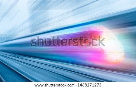 Blue high speed train runs on rail tracks - The train is going too fast as a result the air pressure is causing too much heat at the front Royalty-Free Stock Photo #1468271273