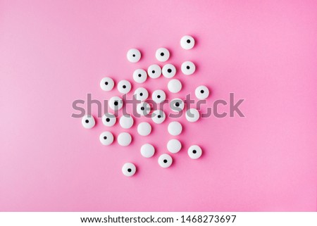 Funny children's treats googly eyes candy for Halloween party on pastel pink color background.Trick or Treat.Creative concept for Halloween.Flat lay,top view,copy space.Horizontal orientation