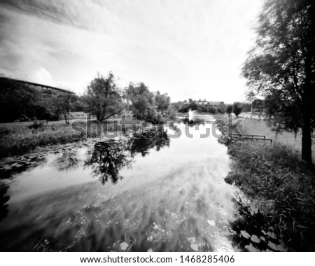 river and trees in the spring, this black and white camera obscura photo is NOT sharp due to camera characteristic. Taken on analogue photographic large format negative film with a pinhole camera