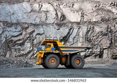 A picture of a big yellow mining truck at work site