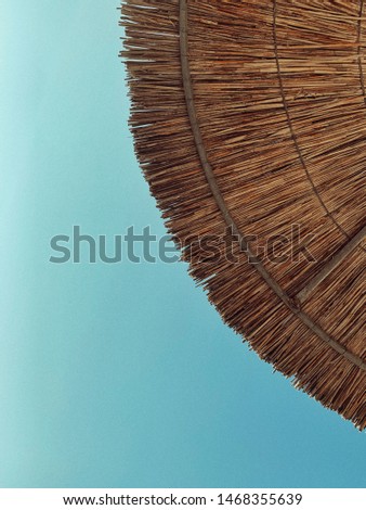 It’s time for the beach. Wooden Umbrella Under the Blue Sky