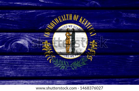 State of Kentucky flag painted on wooden background, closeup.