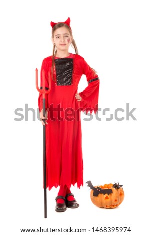 Girl in Halloween devil costume over a white background