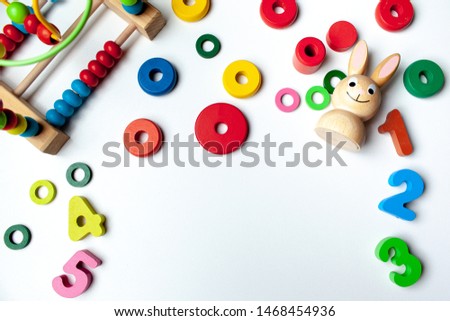 Top view on multicolor toy bricks on white background. Children toys on the table.