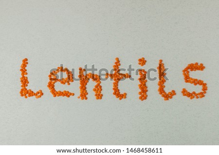 Red lentils inscription on white top view legumes.Lentils are rich in vegetable protein and are eaten since prehistoric times.