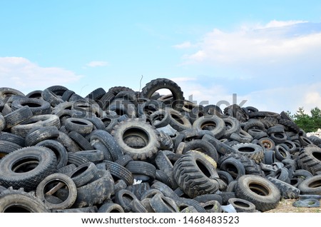 Industrial landfill for the processing of waste tires and rubber tyres. Pile of old tires and wheels for rubber recycling. Tyre dump Royalty-Free Stock Photo #1468483523