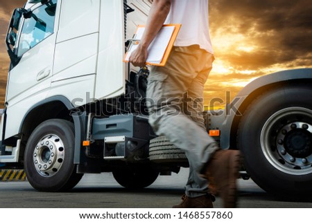Truck Driver is Checking the Semi Truck's Engine Maintenance Checklist. Lorry Driver. Inspection Truck Wheels Tires Safety Driving. Shipping Cargo Freight Truck Transport. Royalty-Free Stock Photo #1468557860