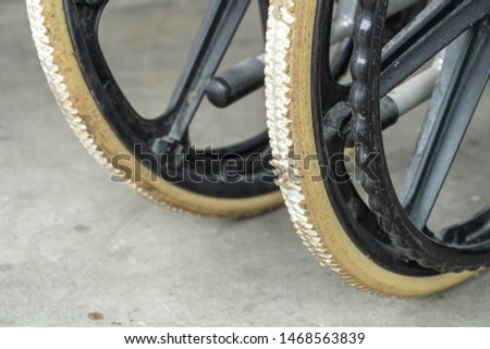 Degenerate flat-free tires of old wheelchair. Wheelchair tyres get worn out with time.