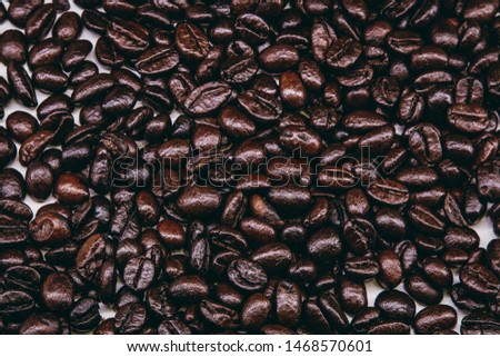 Dark Coffee beans. Isolated vintage style. Roasted Dark coffee beans background.roasted coffee beans, can be used as a background.